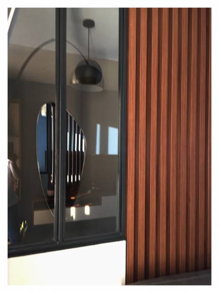 une claustras à l'entrée avec une verrière pour marquer l'entrée